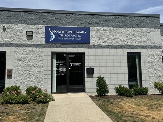 Exterior view of a building with North River Family Chiropractic signage above the entrance.